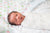 Safely Swaddled Baby In Crib